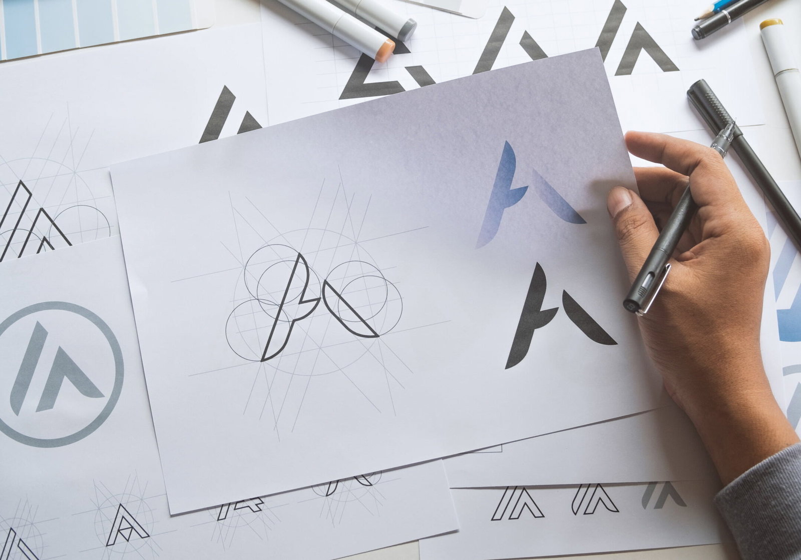 Graphic designer development process drawing sketch design creative Ideas draft Logo product trademark label brand artwork. Graphic designer studio Concept.