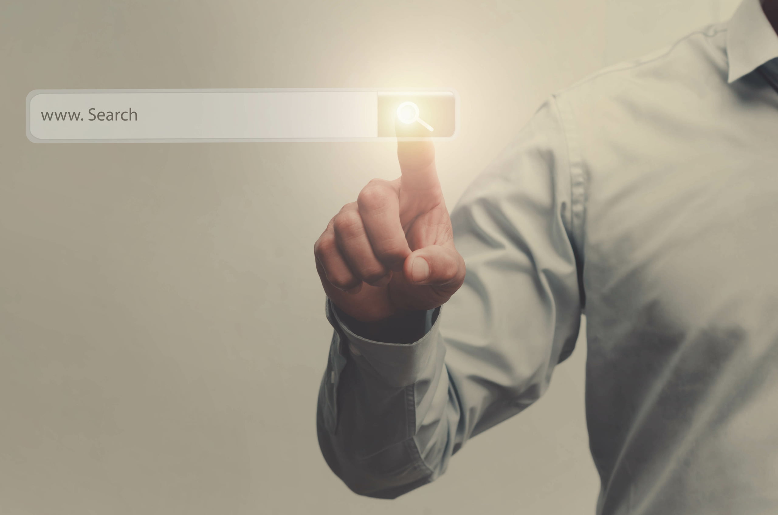 businessman search button on virtual touch screen pressed with finger, vintage soft focus picture concept
